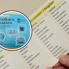 Un libro con frases en euskera y un menú de restaurante con platos en euskera y español.