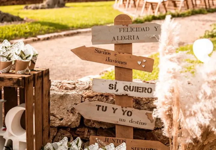 Señalización rústica con frases románticas como "Sí, quiero" y "Tu y yo, un destino". Ideas para rincones de boda.