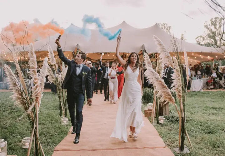 La entrada de los novios al banquete, con bengalas de humo naranja y azul, marca el inicio de la celebración.