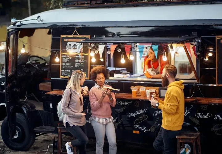 Gente disfrutando de comida deliciosa de food trucks.