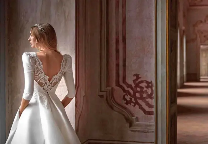 Novia con velo y vestido de encaje, contemplando diferentes tipos de boda en un palacio.