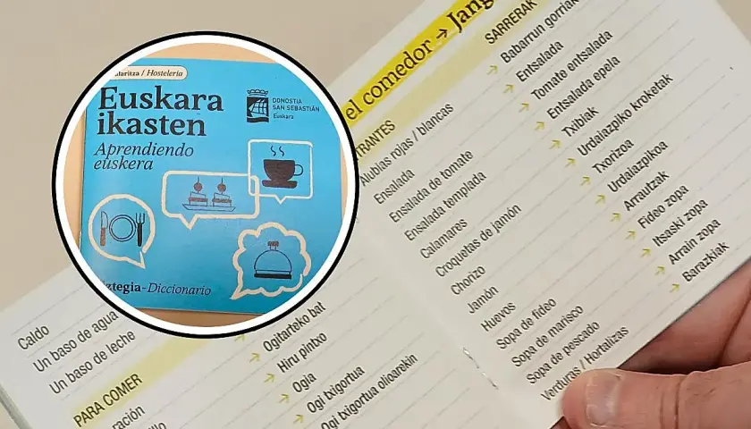 Un libro con frases en euskera y un menú de restaurante con platos en euskera y español.