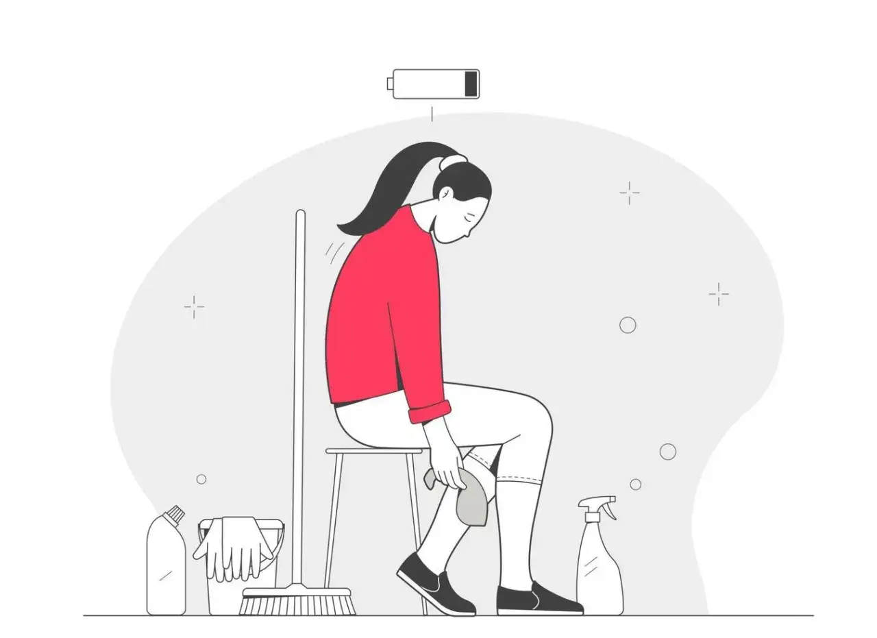 Mujer sentada, agotada, con la bater&iacute;a a punto de agotarse. A su lado, productos de limpieza y escoba. As&iacute; me siento hoy, porque estoy tan cansada y sin ganas de hacer nada.
